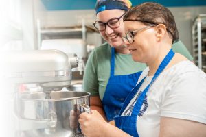 intellectual disabilities support, 2 young women in the kitchn with a mixer